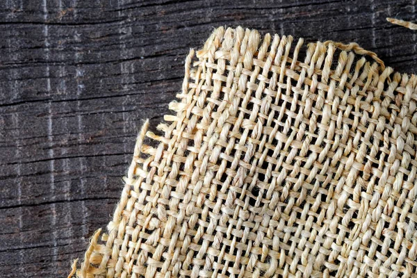 Wood table with old sackcloth burlap tablecloth texture — Stock Photo, Image