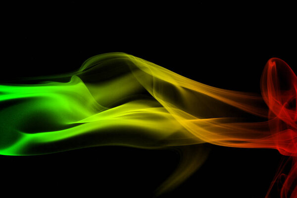 Abstract background smoke curves and wave reggae colors green, yellow, red colored in flag of reggae music