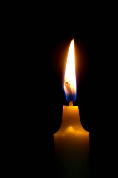 One light candle burning brightly on black background. — Stock Photo, Image