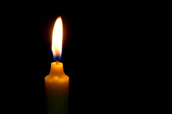 One light candle burning brightly on black background. — Stock Photo, Image