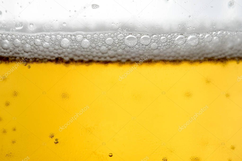 Pouring beer with bubble froth in glass for background 