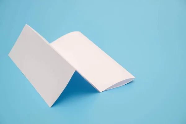 Template fold white paper on blue background — Stock Photo, Image