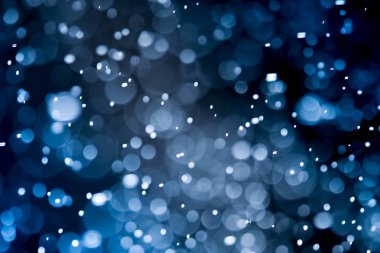 Bokeh 'te noel arkaplanı deseni soyut ışık parıldayan yıldızlar. simli klasik ışık arkaplanı