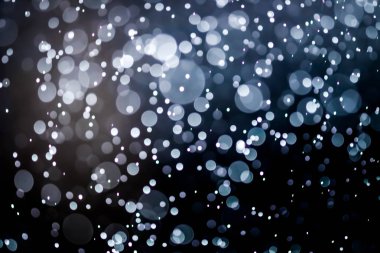 Bokeh 'te noel arkaplanı deseni soyut ışık parıldayan yıldızlar. simli klasik ışık arkaplanı