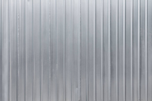 Industrial background, corrugated metal sheet used as temporary wall in construction