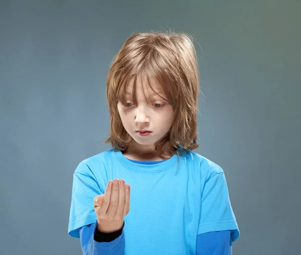 Boy in Blue Top Looking at his Hands — Stock Photo, Image