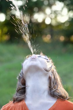 Wet Boy Fooling Around Squirting Water clipart