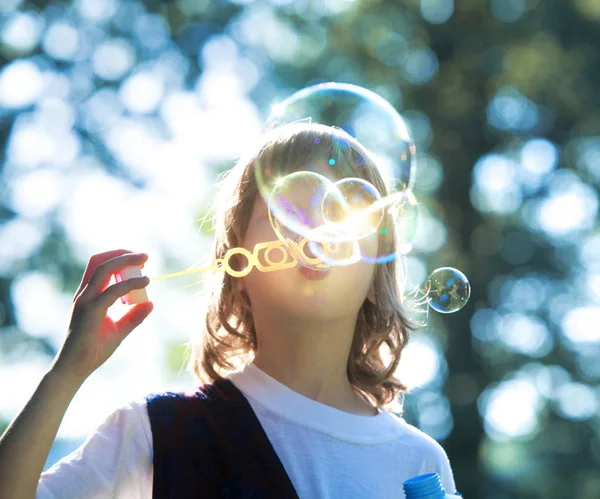 Boy Blowing Soap Bubbles Outdoor. — Stock Photo, Image