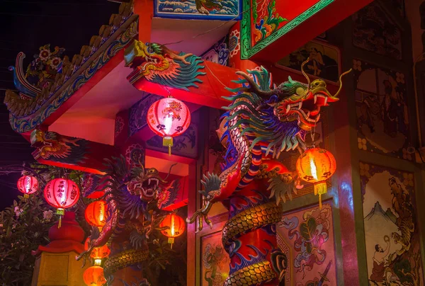 Традиционный китайский храм с драконами и огнями на колоннах ночью на Ко Самуи (Koh Samui) — стоковое фото