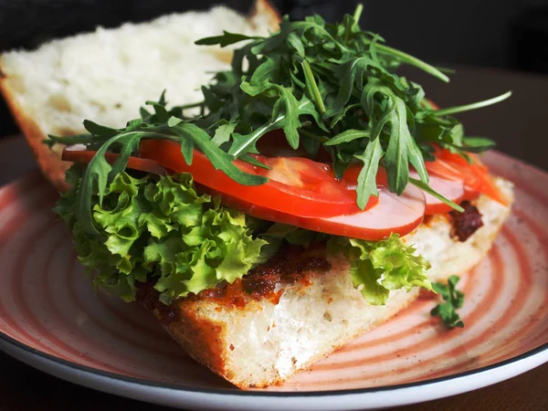 Jambon, yeşil ve beyaz ekmek bir plaka üzerinde sandviç
