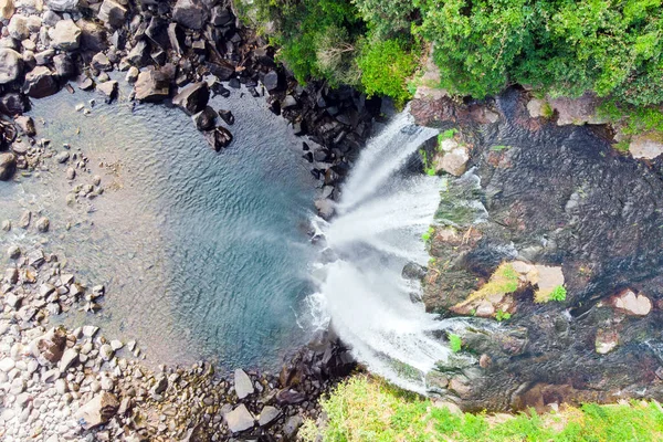 Looking Down Aerial View of The High Waterfall Jeongbang and Lagoon on Jeju Island, South Korea.