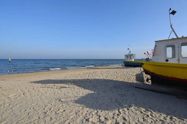 stock image Fishing boats onshore with a sea landscape in the background