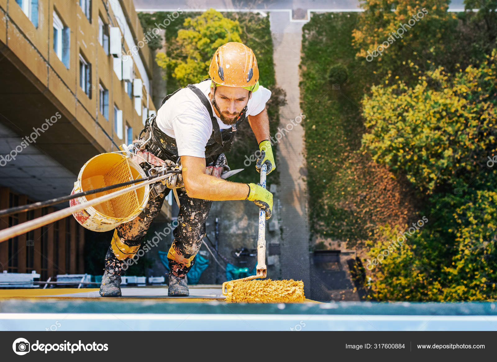 Industrial rope access worker hanging from the building while painting the  exterior facade wall. Industrial alpinism concept image. Top view — Stock  Photo © predragmilosavljevic88@gmail.com #317600884