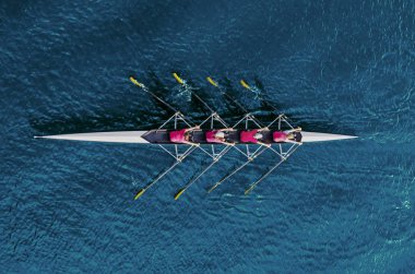 Women's rowing team on blue water clipart