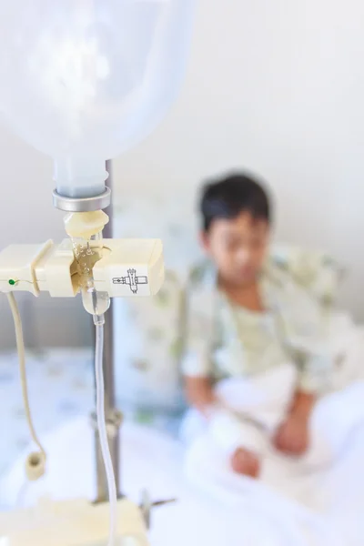 Aziatische jongen zittend op bed met infusie pomp Iv infuus — Stockfoto