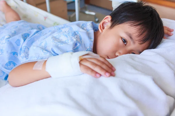 Illness asian boy with saline intravenous (IV) on hand. Health care and people concept. — Stock Photo, Image