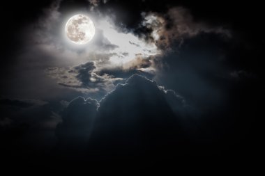 Nighttime sky with clouds, bright full moon would make a great background. clipart