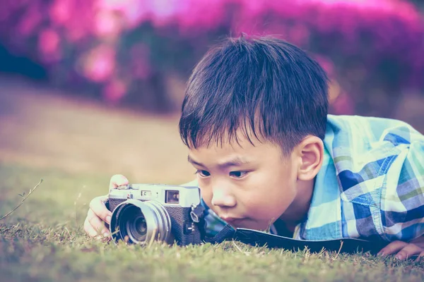 Jongen nemen foto door de camera, het verkennen van de natuur in het park. — Stockfoto