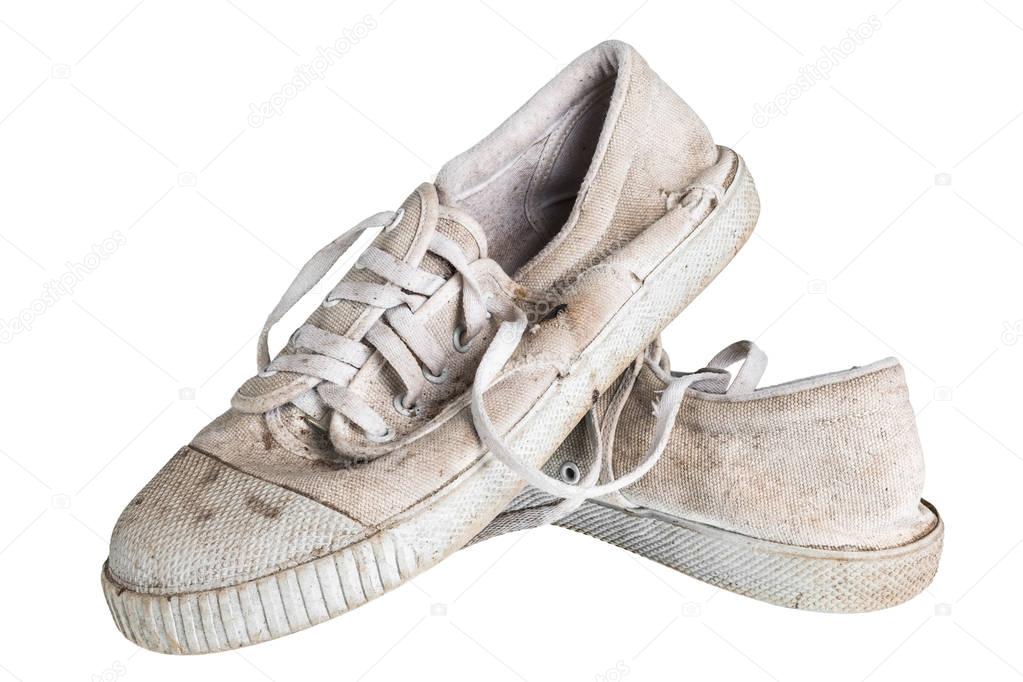 Close up a pair of dirty sneakers. Isolated on white background.