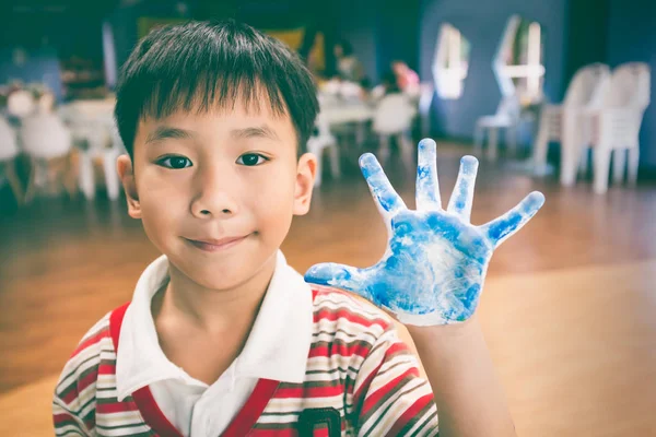 Asian painter shows his painted palms on art class. Education and learning concept. — Stock Photo, Image