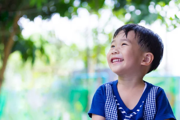 Happy asijské boy vzhlížel parku. Venku v denní době cestování na dovolenou. — Stock fotografie