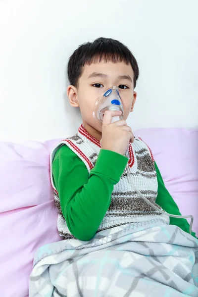 Азиатский ребенок держит ингалятор пара маски для лечения астмы . — стоковое фото