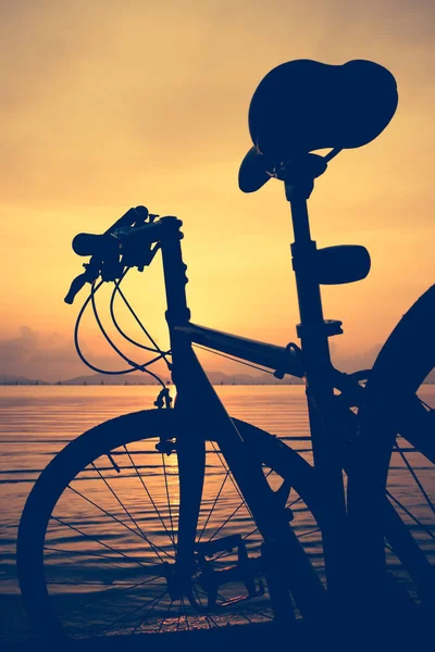 自行车对多彩的日落海滩上的剪影 — 图库照片