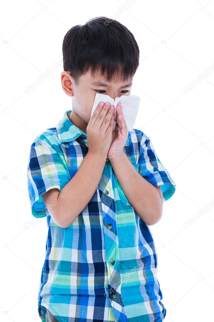 Asian boy using tissue to wipe snot from his nose. Isolated on white background.