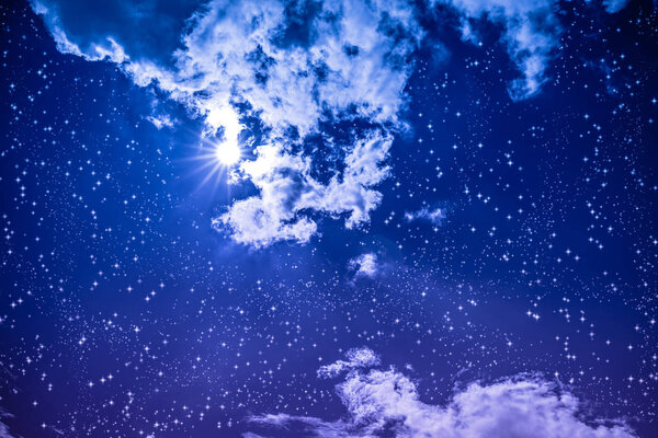 Amazing blue dark night sky with many stars, bright full moon and cloudy. Outdoor at nighttime with moonlight. Vivid colors. Pretty nature use as background.