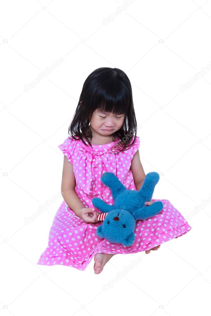Child with tears. Asian girl sitting with toy bear, sadden and crying.