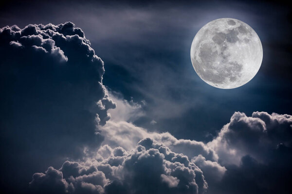 Attractive photo of background night sky with cloudy and bright full moon. Nightly sky with beautiful full moon. Vintage tone effect. The moon were NOT furnished by NASA.