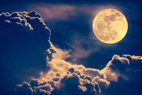 Nighttime sky with clouds and bright full moon with shiny.  