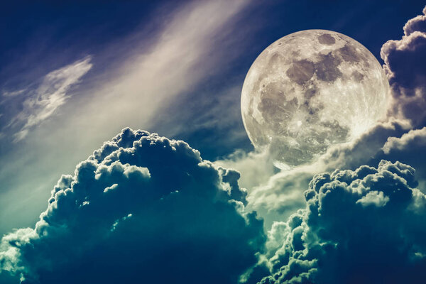 Super moon. Attractive photo of background night sky with cloudy and bright full moon. Nightly sky with beautiful full moon behind clouds. Cross process. The moon were NOT furnished by NASA.