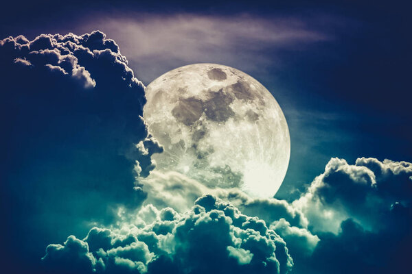 Super moon. Attractive photo of background night sky with cloudy and bright full moon. Nightly sky with beautiful full moon behind clouds. Cross process. The moon were NOT furnished by NASA.