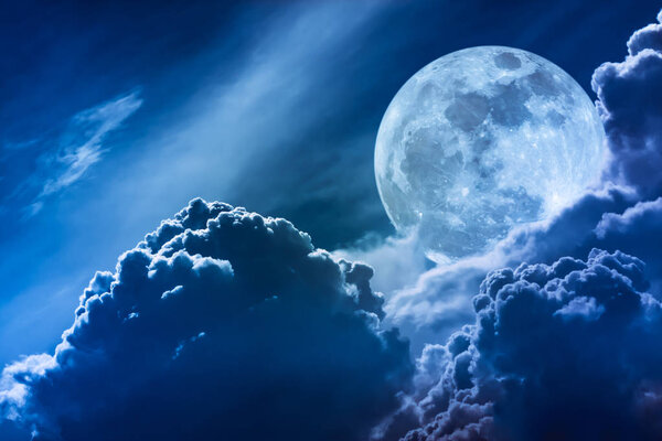 Super moon. Attractive photo of background night sky with cloudy and bright full moon. Nightly sky with beautiful full moon behind clouds. The moon were NOT furnished by NASA.