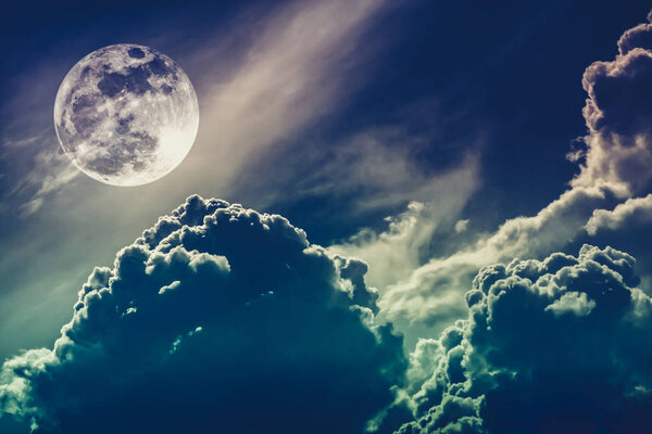 Attractive photo of background night sky with cloudy and bright full moon. Nightly sky with beautiful full moon behind clouds. Cross process. The moon were NOT furnished by NASA.