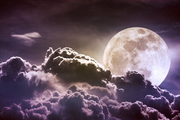 Super moon. Attractive photo of background night sky with cloudy and bright full moon. Nightly sky with beautiful full moon behind clouds. Vintage tone effect. The moon were NOT furnished by NASA.