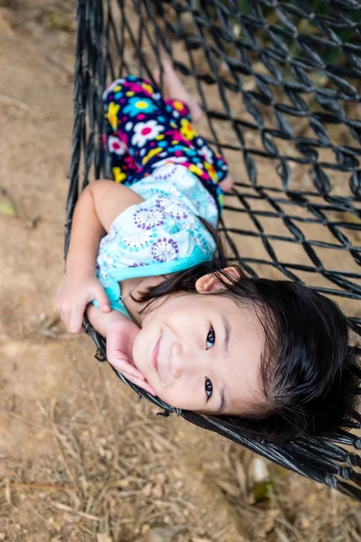 Criança alegre desfrutando e relaxando na rede, ao ar livre no dia de verão . — Fotografia de Stock