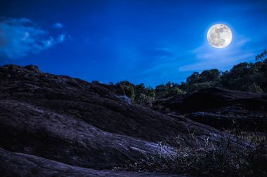 Manzara mavi gökyüzünde bulut ve güzel dolunay ile. Koyu tonu.