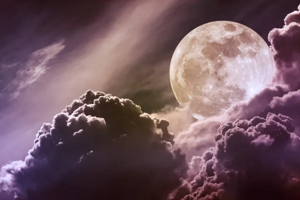 Nighttime sky with clouds and bright full moon with shiny.  Vintage effect tone.