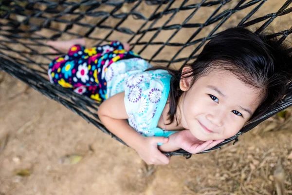 Cheerful child enjoying and relaxing in hammock, outdoor on summer day. — Stock Photo, Image