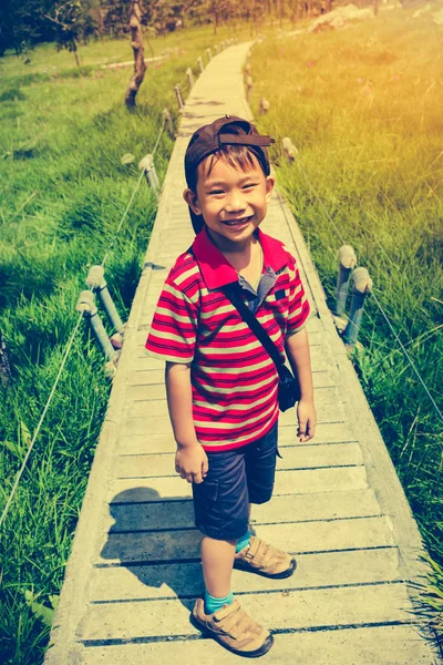 Happy asian boy relaxing outdoors in the daytime, travel on vacation. — Stock Photo, Image