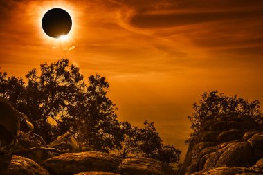 Amazing scientific natural phenomenon. Total solar eclipse glowing on sky and cloudy clipart