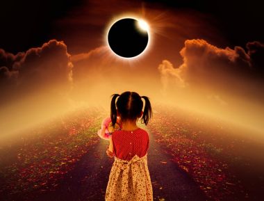Total solar eclipse glowing above child on pathway with night sky and clouds.  clipart