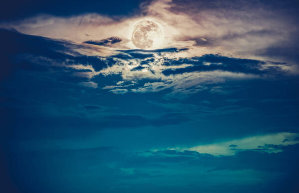 Attractive photo of background nighttime with cloudy. Landscape of night sky with beautiful full moon, serenity nature background. Cross process. The moon taken with my own camera.