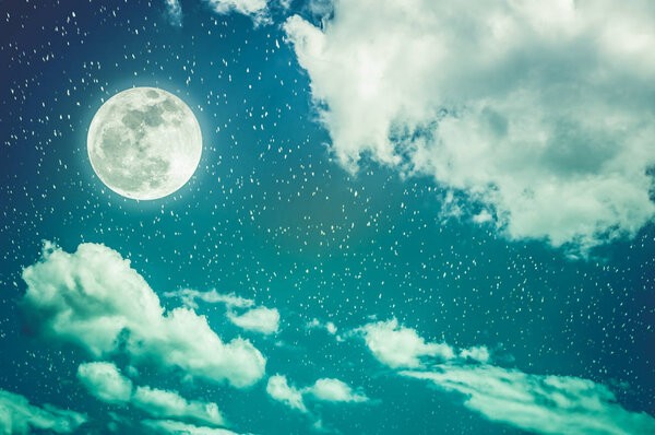 Beautiful cloudscape with many stars. Night sky with bright full moon and cloudy, serenity blue nature background. Outdoor at nighttime with moonlight. Cross process. The moon taken with my own camera.