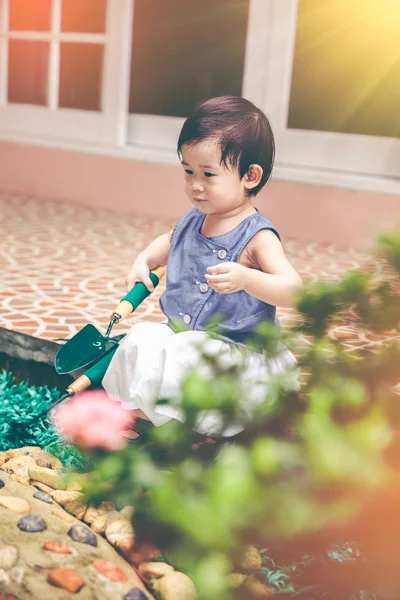 Niño asiático con equipo de jardinería. Al aire libre para niños. Tono vintage . — Foto de Stock