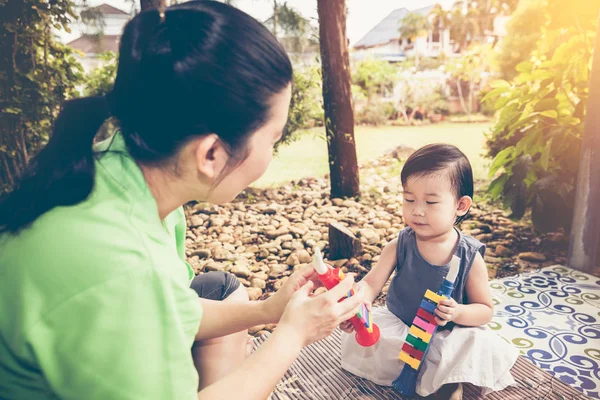 アジアの母は彼女の娘と一緒にトランペットのプラスチック パイプを再生します。Vin — ストック写真