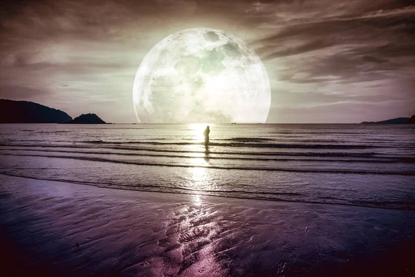 Super moon. Colorful sky with cloud and bright full moon over sea. Serenity nature background.