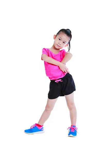 Full body of adorable asian child in sportswear doing exercise. Isolated on white background. — Stock Photo, Image